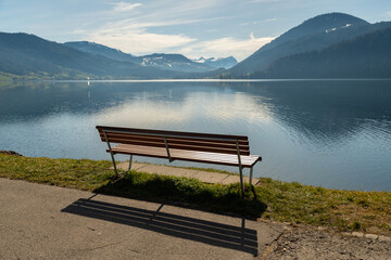 Naklejka na ściany i meble Empty bench at the lake Aegerisee in Switzerland