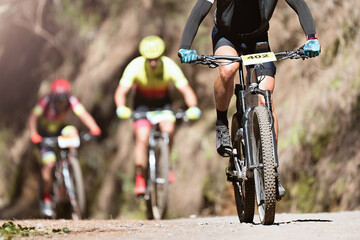 Mountain bikers riding on bike singletrack trail, mountain bike race