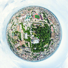 Aerial city view with crossroads and roads, houses, buildings, parks and parking lots, bridges. Helicopter drone shot. Wide Panoramic image.