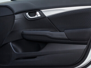 Obraz na płótnie Canvas Modern car door panel close-up view. Door lock opening switches