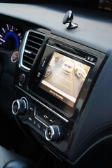 Modern car multimedia system and air conditioning control panel close-up view