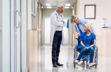 Fototapeta na wymiar Professional medical doctor team with stethoscope in uniform discussing with patient woman with cancer cover head with headscarf of chemotherapy cancer in hospital.health care concept