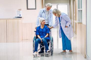 Professional medical doctor team with stethoscope in uniform discussing with patient woman with cancer cover head with headscarf of chemotherapy cancer in hospital.health care concept