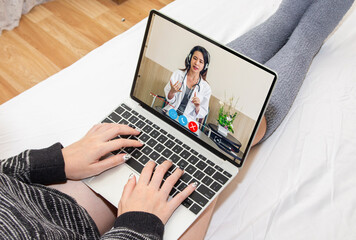 Woman talk speak using laptop computer and video conference online with doctor and stethoscope service help support team discussing and consulting talk video chat call checkup information at home