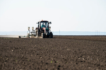 Fototapeta premium Sowing crops at agricultural fields in spring