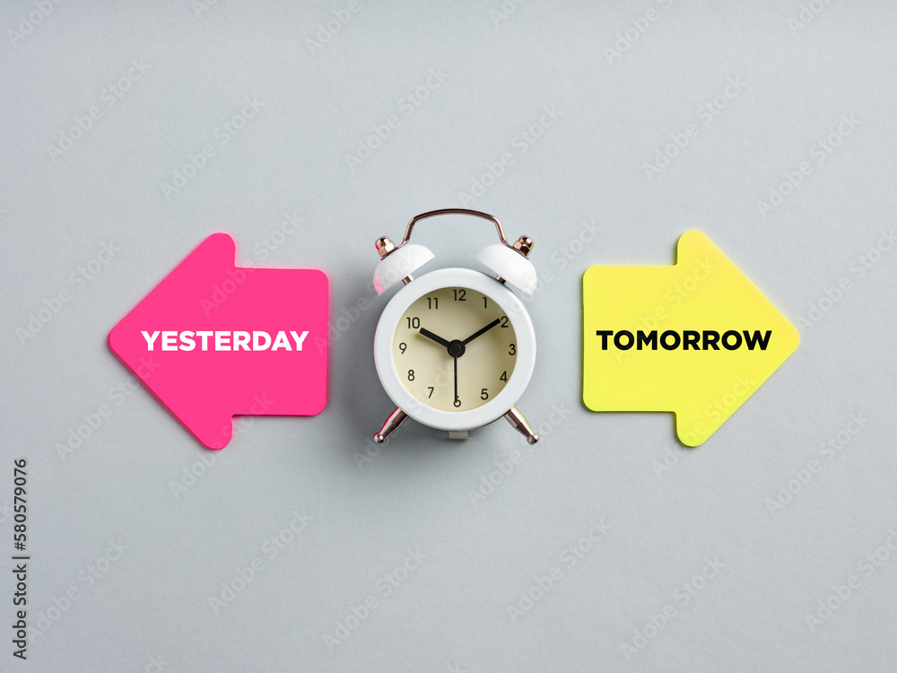 Poster yesterday and tomorrow written on arrow note papers next to a clock. adapting to change, improvement