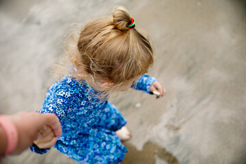 Little cute toddler girl at the Ballybunion surfer beach, having fun on with playing on west coast...