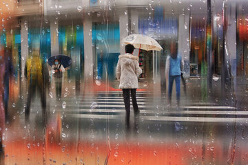 people with an umbrella in rainy days in winter season, bilbao, basque country, spain