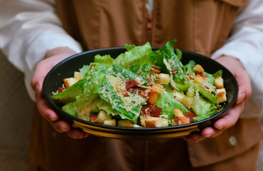 Caesar salad served with organic lettuce, crispy bread and sprinkled with cheese is a meal for health lovers.