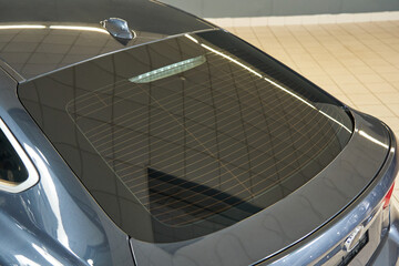 gray premium car rear window, glass heating system. fin air divider on car roof