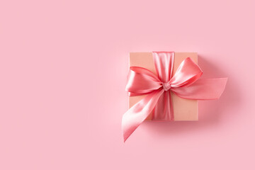 Pink gift box with bow on pink background