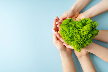 Naklejka na ściany i meble World earth day concept with green plant heart on blue background,