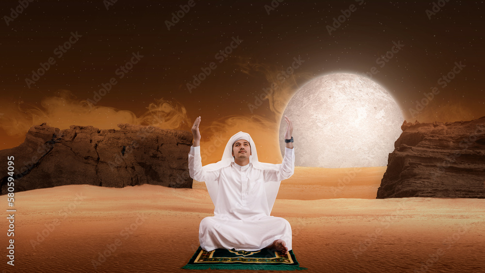 Wall mural muslim man sitting while raised hands and praying