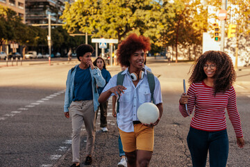 Fototapeta premium Happy students walking in city.