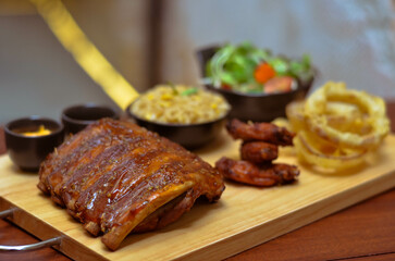 BBQ ribs set served with fried rice, fried chicken wings and onion rings and Japanese salad