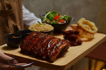 BBQ ribs set served with fried rice, fried chicken wings and onion rings and Japanese salad