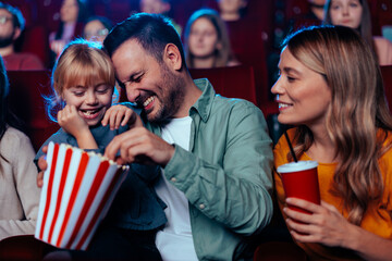 Happy family in movie theater.