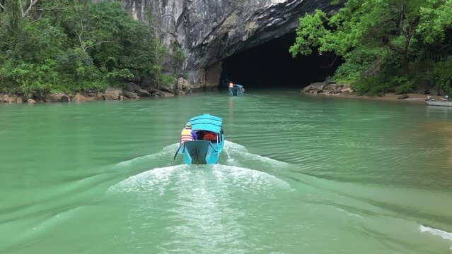 Tourists boat entering Phong NHA underground river cave, Aerial 
Quand bing province Vietnam, february,15, 2023

