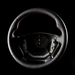 Professional restoration of a leather-wrapped steering wheel with red stitches.