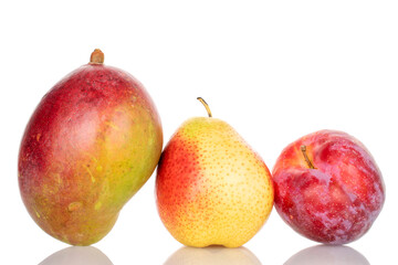 One juicy pear with mango and red plum, close-up, on a white background.
