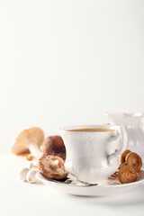 Mushroom Chaga Coffee Superfood, fresh mushrooms and coffee in white porcelain vintage cup over white background. New Superfood Trend. Copy space