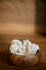 Traditional Turkish delight in a wooden cup in sunlight - 580600432