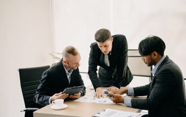 Business team discuss at meeting room. working together with laptop ,tablet and smart phone on desk Financial accountant , planner , meeting , introduction concept. At office.