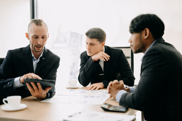 Business team discuss at meeting room. working together with laptop ,tablet and smart phone on desk Financial accountant , planner , meeting , introduction concept. At office.
