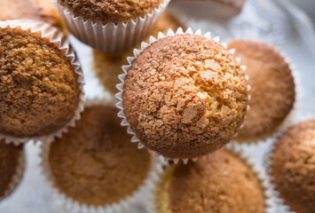 Overhead view of a group of freshly baked cupcakes with shallow depth of field.