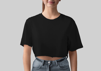 Mockup of black crop top on smiling girl, blank canvas bella shirt, front view, isolated on background.