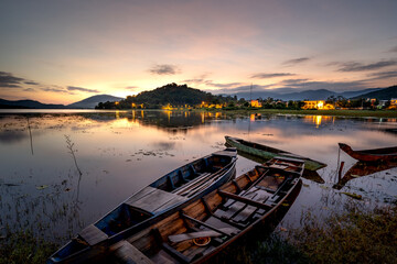 Beautiful sunrise at Lak lake in Buon Ma Thuat, Dak Lak province, Vietnam with a focus on the boat....