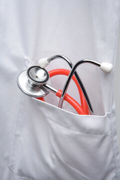 Stethoscope in the pocket of a white doctors coat close up