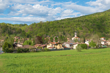 Protected green area in north Italy. Campo dei Fiori regional park with the village of Brinzio at the foot of the Campo dei Fiori massif, province of Varese, Lombardy