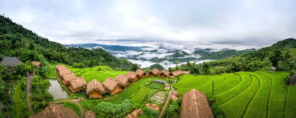 Enjoy a panoramic view of wooden bungalows from above with breathtaking views of the mountains and terraced fields where you can can relax and be in har at resort Hoang Su Phi Lodge, Vietnam