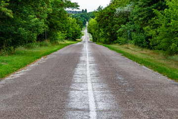 Beautiful empty asphalt road in countryside on colored background