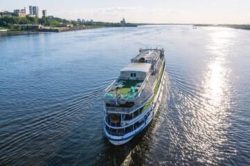 The ship is moving along the river. A deck for relaxing on a pleasure ship. Summer navigation on...