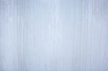 Gray background of decorative plaster with abstract spots. Unusual silver wall texture with beautiful patterns, creative surface background. Dressing coating for building cladding.