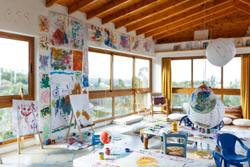 Daylight Art Studio Interior with Large Windows, Multiple Stretched Canvases and pictures on wall, master classes for children,creative space