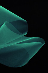 Futuristic abstract background. Translucent unusual shapes. Organza on a dark background. Green fabric texture.