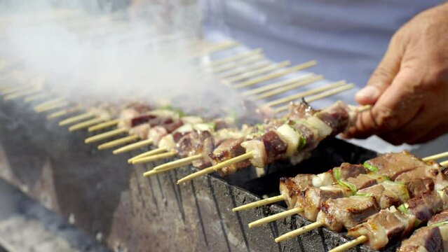 cooking typical italian arrosticini on barbecue
