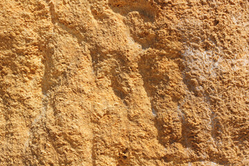 Abstract background with the texture of yellow wet sand or rock