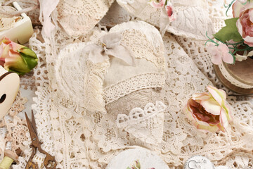 Vintage style handmade hearts sewn of linen and laces on the table