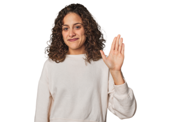 Radiant young woman with stunning curls smiling cheerful showing number five with fingers.