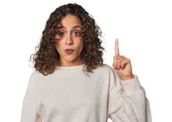 Radiant young woman with stunning curls having an idea, inspiration concept.