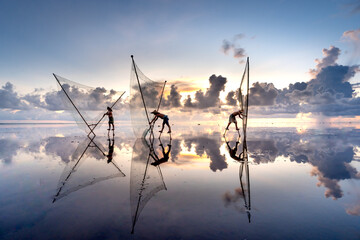 The image of fishermen in the fishing village using homemade tools to clams rake in Diem Dien...