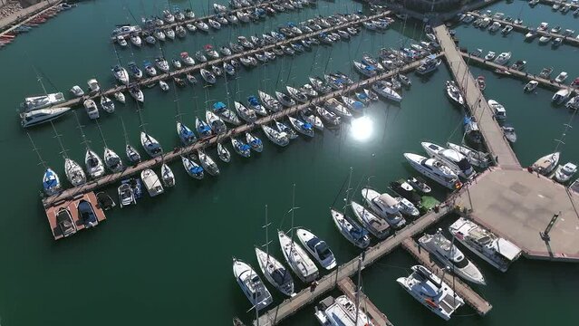 Boats and small sailing Yachts docked in a beautiful marina