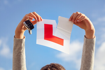 Tearing up L plate after passing driving test - obrazy, fototapety, plakaty