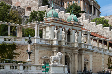 Exterior view of the Neorenaissance Castle Garden Bazaar (Várkert Bazár) in Budapest, Hungary, Europe. Statues, ornaments, columns, and turquoise domes of the historical building on Ybl Miklós square.