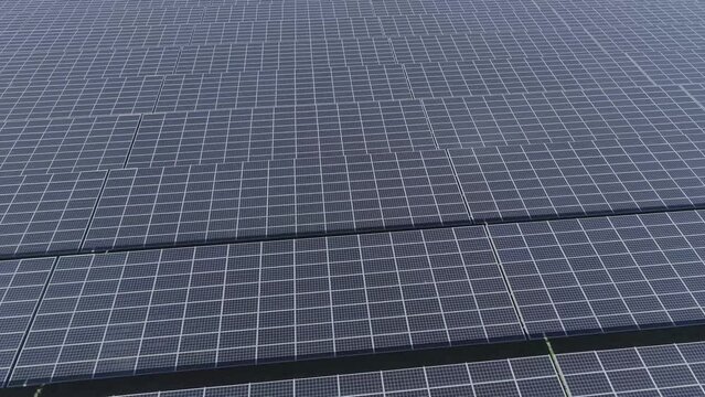 Close drone shot of rows of solar panels. 