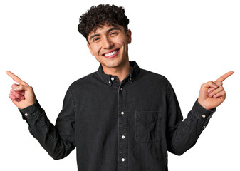 Young latin man pointing to different copy spaces, choosing one of them, showing with finger.